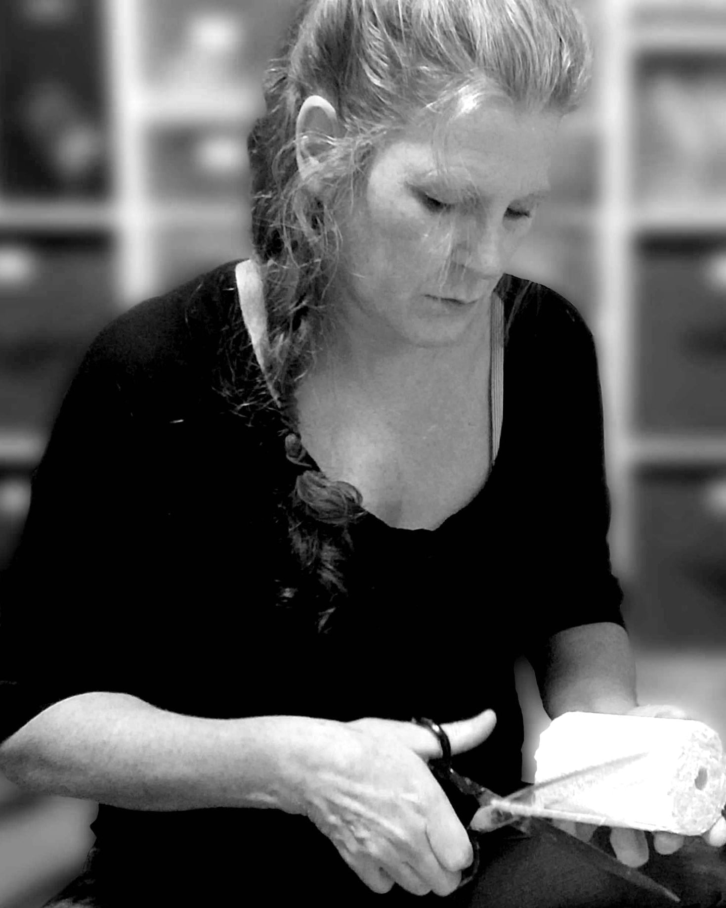 A black and white photo of Gabby working with plaster casting rolls