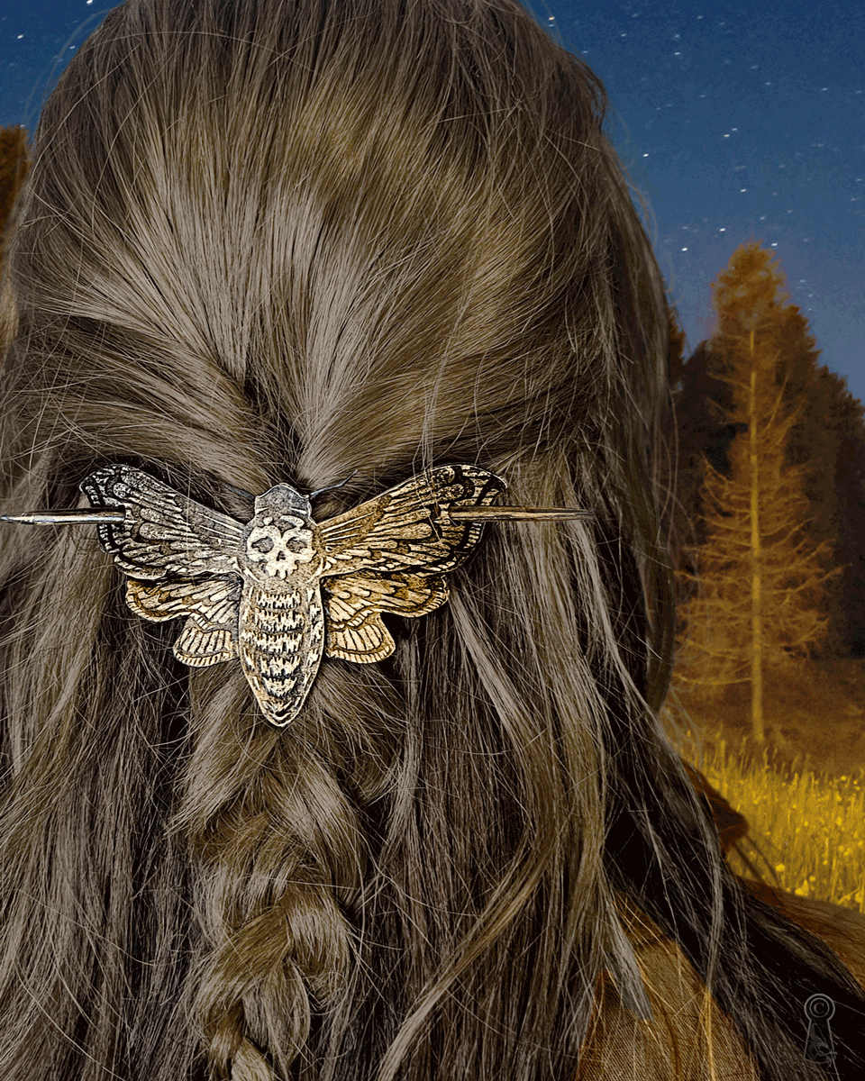 Death's head moth hair slide in braided hair with a forest background