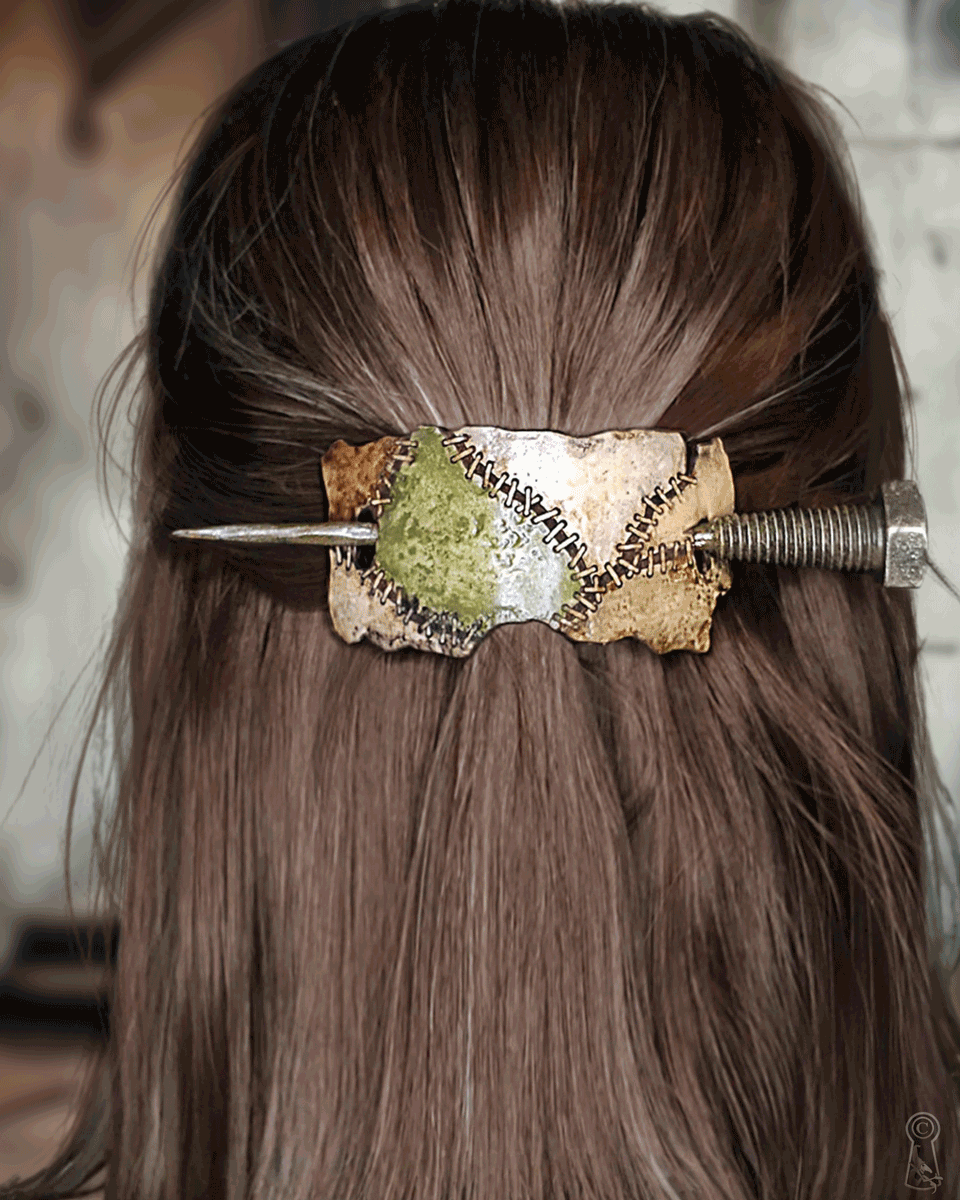Hair accessory with a decorative stitched colors and a metal bolt on brown hair
