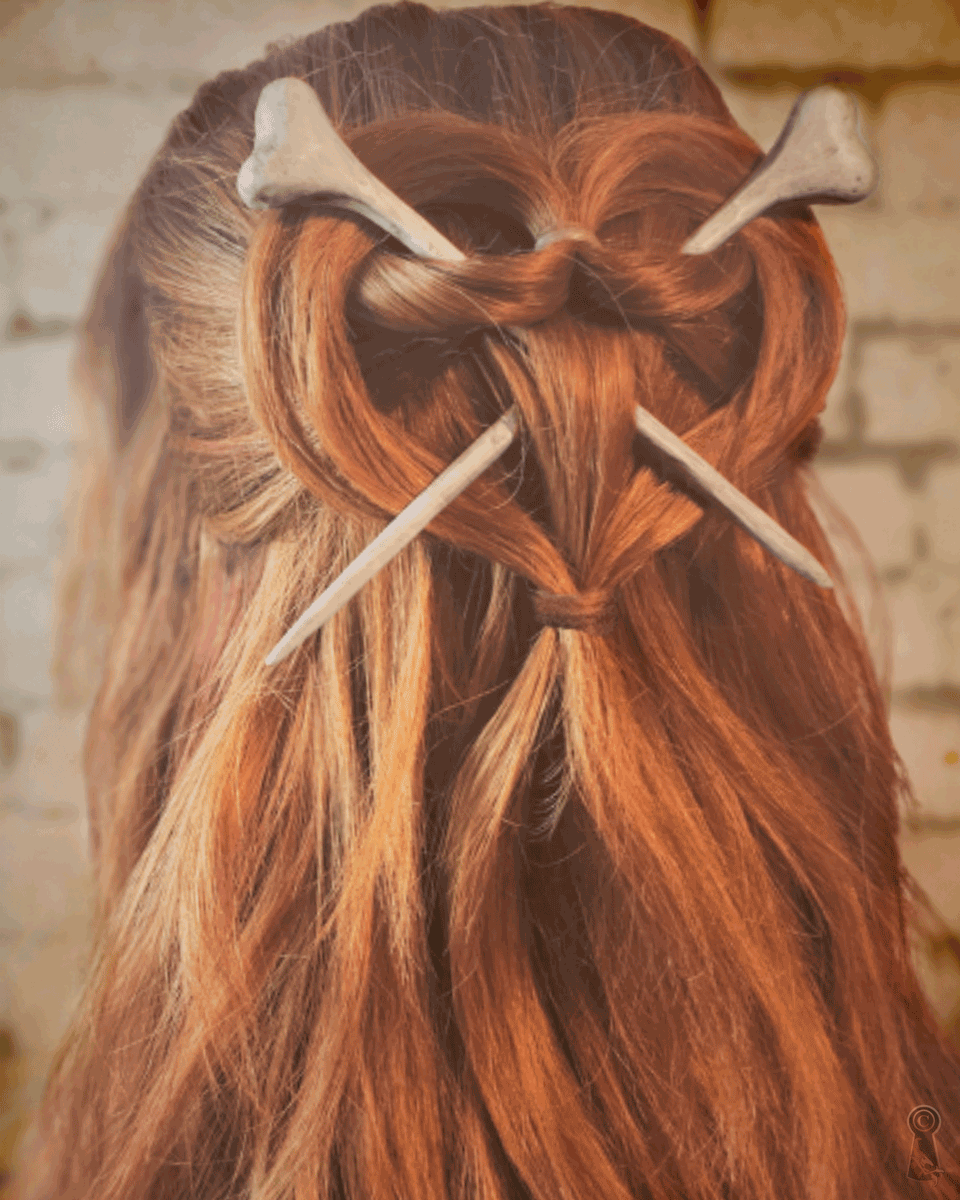 Hair styled in a decorative heart with 2 bones hair sticks.