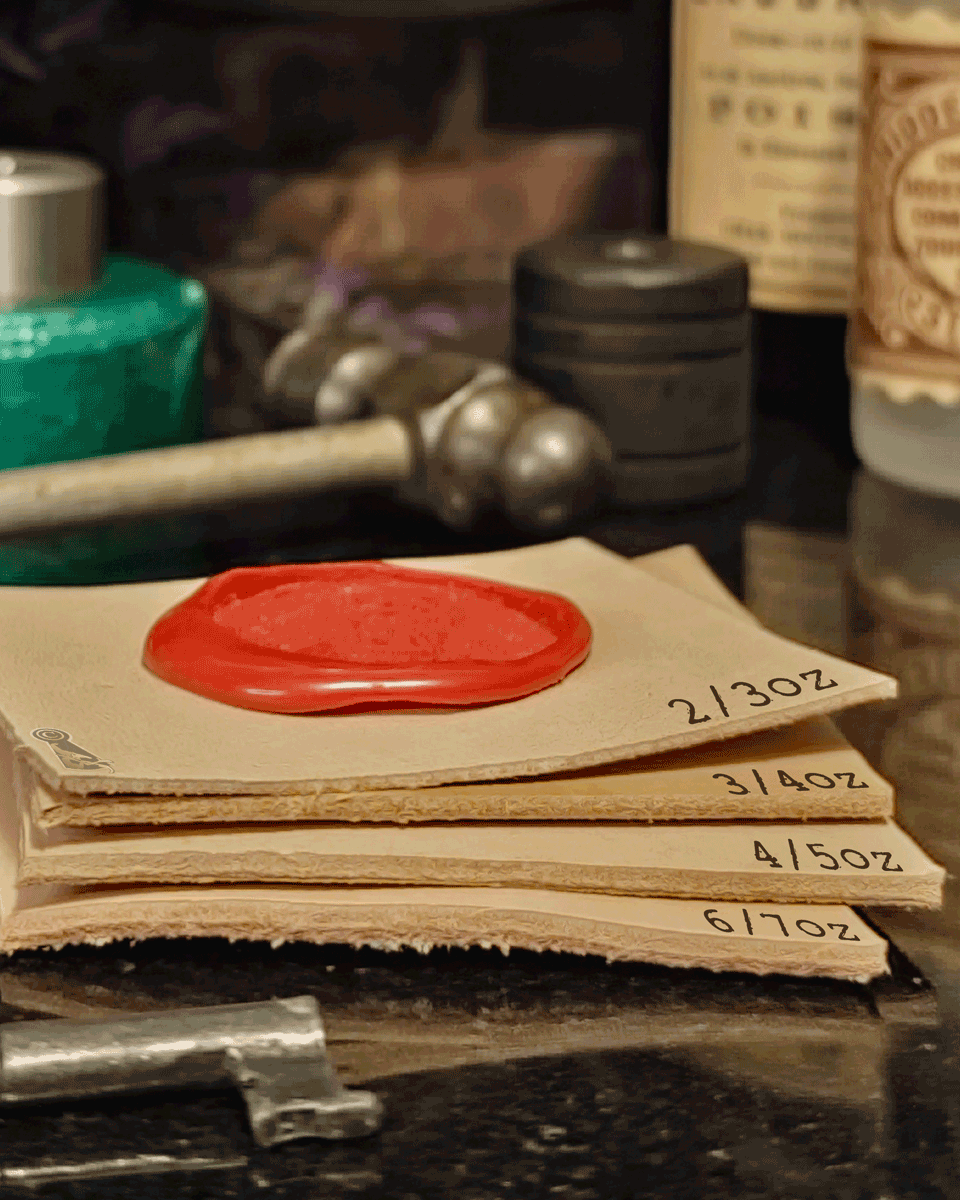 Stack of thickness labeled leather cuts with a red wax seal, surrounded by vintage tools and bottles.