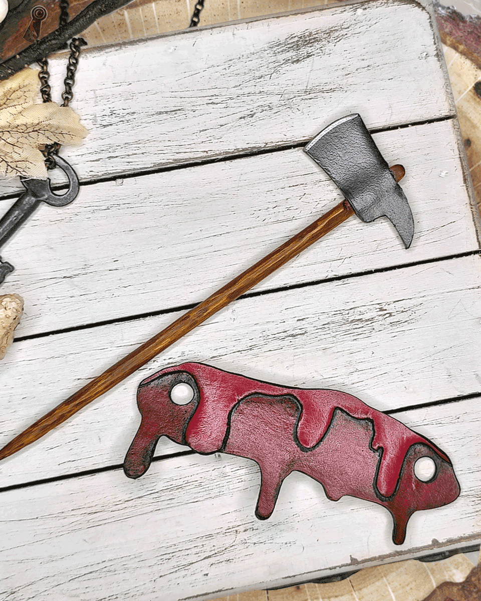 Axe with wooden handle and blood drip  separated on a white wooden surface
