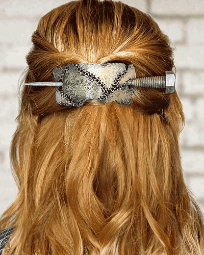 Long red hair with a decorative hair accessory against a neutral background