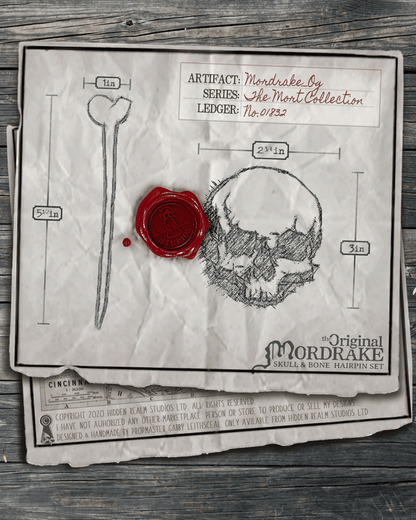 Paper page with the skull and bone hairpin design illustrated, red wax seal, and measurement details on a rustic wooden background.