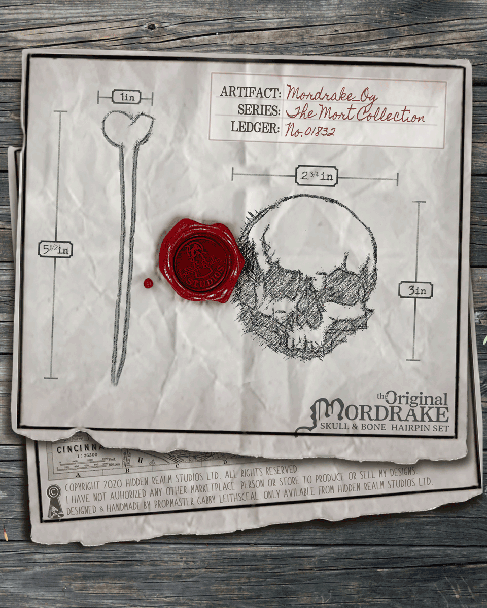 Paper page with the skull and bone hairpin design illustrated, red wax seal, and measurement details on a rustic wooden background.