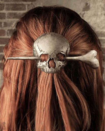 Close-up of a leather skull hairpin set with wood and resin bone stick worn in hair.