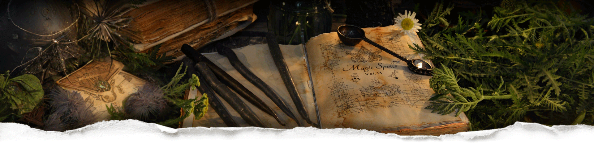 Vintage book of spells and maths with candles, plants and bottles behind torn paper